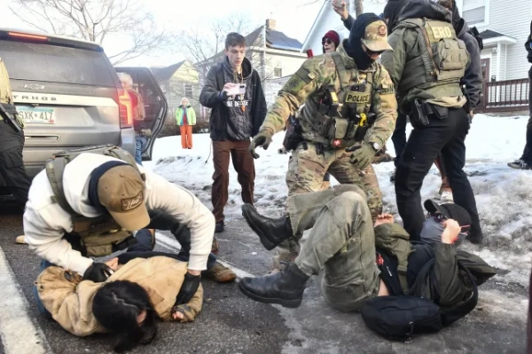 ICE та інші федеральні співробітники затримують особу під час протестів, поки ICE працює в житловому районі Міннеаполіса, штат Міннесота, 13 січня 2026 року. Ще сотні федеральних агентів прямували до Міннеаполіса, заявив 11 січня керівник Служби внутрішньої безпеки США, відхиливши вимоги лідерів демократів міста на Середньому Заході залишити місто після того, як імміграційний офіцер смертельно застрелив жінку-протестувальника. У численних телевізійних інтерв'ю міністр внутрішньої безпеки США Крісті Ноем захищала дії офіцера, який застрелив 37-річну Рене Ніколь Гуд, смерть якої викликала поновлення протестів по всій країні проти імміграційних репресій президента Дональда Трампа. (Фото Октавіо Джонса / AFP via Getty Images)