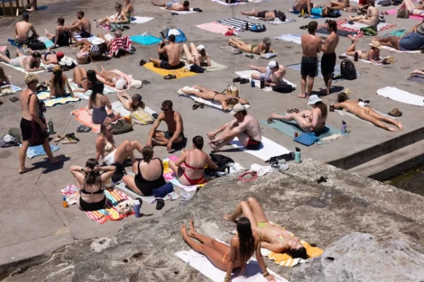 6 січня 2026 року люди стікаються на пляж Кловеллі в Сіднеї, Новий Південний Уельс, Австралія, щоб насолодитися сонцем і морем, оскільки найближчими днями по всій країні очікується висока температура.