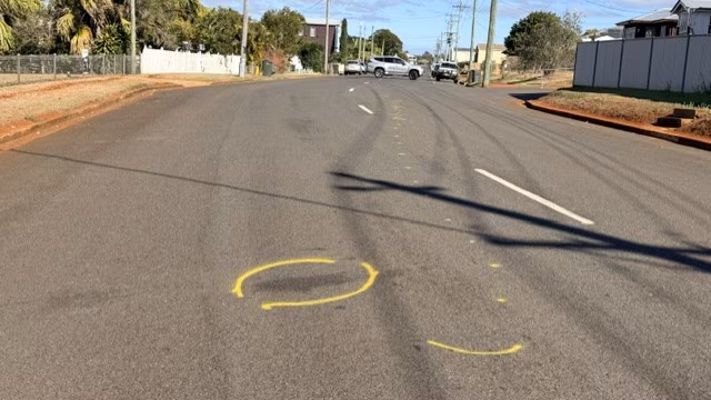 An empty road with yellow marking on it.