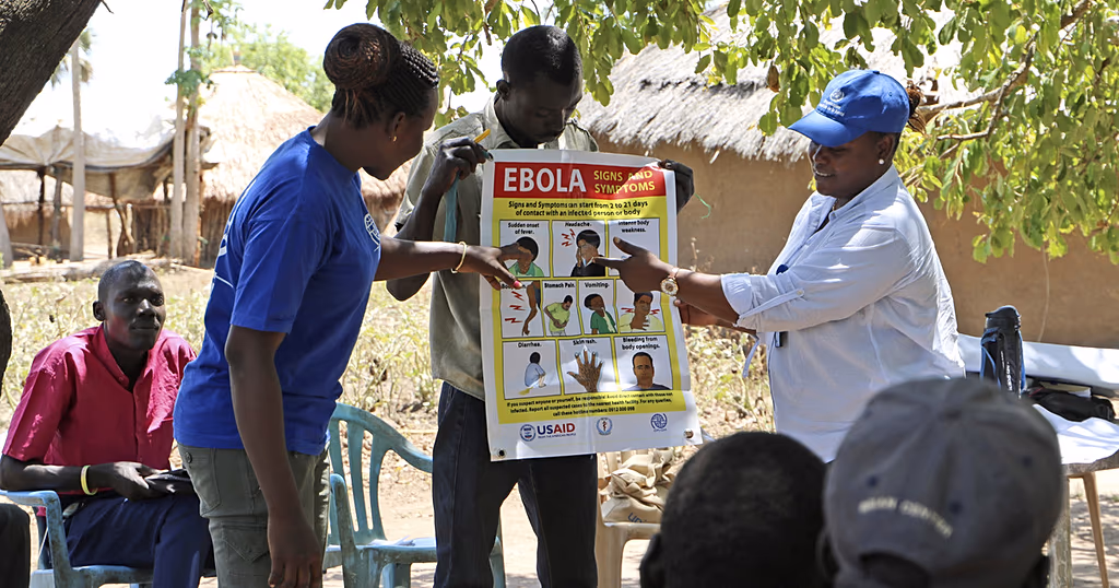 Health workers giving a training presentation about how to detect and prevent the spread of Ebola, outside Yei, South Sudan.