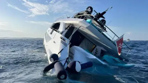 Pictured: The ?6.8m superyacht sinks in the Med. A ?6.8m superyacht has sunk in the Med just four days after being delivered to its new owner. Footage shows the luxury vessel slowly submerging before rolling onto its side, with just a sliver of the yacht remaining above the surface. It was secured following an operation lasting nearly three hours, as reported by NeedToKnow. Since Tuesday (11 August) evening, the yacht has been lying on its side on the 7m (23ft) deep seabed. The nearly 30m (98ft) yacht was reportedly delivered to its Italian owner just four days before the sinking, following an extensive refit. The Angiola II sank in waters off Porto Cervo, Sardinia, between Cappuccini Island and Capo Ferro. It is believed to have lost buoyancy after an engine failure caused a fire in the seals, allowing water to enter the vessel. However, the exact cause of the flooding and sinking has yet to be officially determined. Fourteen people, including guests and crew, were on board at the time of the incident. Twelve were rescued by another vessel sailing nearby, while the owner and a friend remained on the stricken yacht awaiting the arrival of a patrol boat, which transported them to Poltu Quatu. No injuries were reported. Italian media have estimated the yacht?s value at more than ?8m (?6.8m). The Amer F100 had accommodation for up to 10 guests across five cabins. A pontoon weighing approximately 200 tonnes will reportedly be used to remove the wreck. La Maddalena Port Authority is also reportedly taking measures to prevent any environmental damage. ENDS EDITOR?S NOTES Fair Dealing / Fair Use: In limited cases, Jam Press may distribute material under fair dealing/fair use principles for legitimate editorial reporting purposes. Jam Press accepts responsibility for licensed editorial publisher usage only. Any additional client usage, including use across owned social media channels, commercial marketing or non-editorial purposes, remains the responsibility of the client.