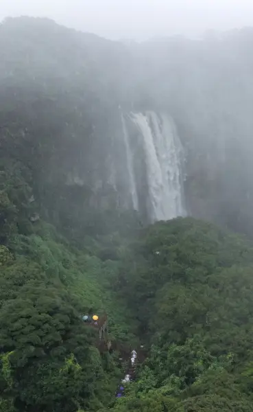 epa13176653 Visitors look at Eongtto Falls in Seogwipo, Jeju Island, South Korea, 18 August 2026, amid a heavy rain warning issued for the region. The waterfall, which remains dry and hidden in the forest most of the time, reveals a powerful torrent only during or immediately after heavy rain.e EPA/YONHAP SOUTH KOREA OUT