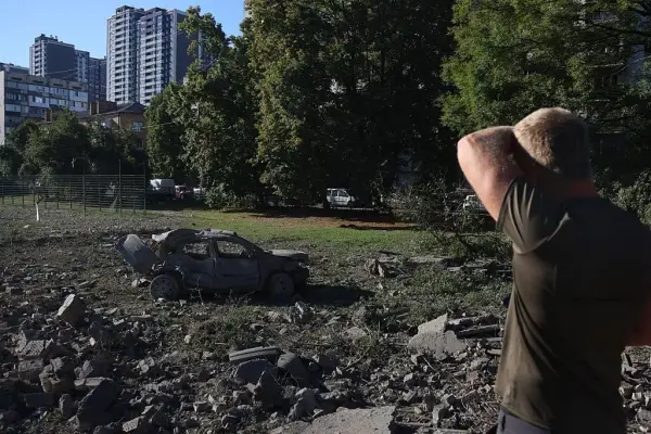 KYIV, UKRAINE - AUGUST 20: A man looks at a car destroyed in a Russian missile attack on August 20, 2026 in Kyiv, Ukraine. As a result of the massive Russian attack on Kyiv, damage was recorded in three residential districts of the city. Russian strikes damaged residential buildings, warehouses, a school and a children???s hospital. City authorities report 12 deaths in Kyiv so far. More than 30 people were injured. Tomorrow, August 21, has been declared a Day of Mourning in Kyiv. In memory of the victims of Russia???s massive attack on Kyiv. (Photo by Viktor Kovalchuk/Global Images Ukraine via Getty Images)