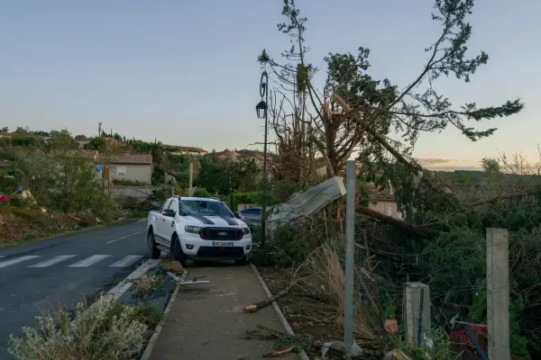 TOPSHOT - This photograph taken on August 24, 2026, shows damaged vehicles and houses after a tornado struck Pomas, southwestern France. A tornado struck the Aude department on August 24 as part of southwestern France remained under an orange storm alert, with several rooftops torn off in the village of Pomas, an AFP photographer at the scene reported. (Photo by Idriss Bigou-Gilles / AFP via Getty Images)