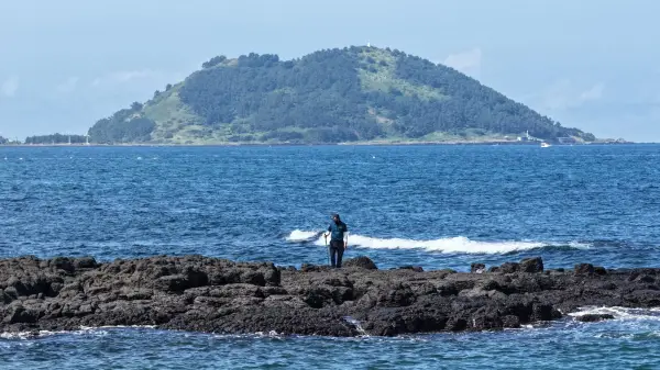 A policeman takes part in a search operation of a missing person Jang Mi-ran in Jeju on the Jeju island, South Korea, August 24, 2026. Yonhap via REUTERS THIS IMAGE HAS BEEN SUPPLIED BY A THIRD PARTY. NO RESALES. NO ARCHIVES. SOUTH KOREA OUT. NO COMMERCIAL OR EDITORIAL SALES IN SOUTH KOREA.
