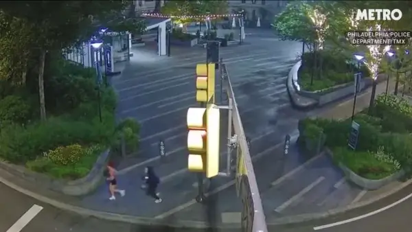 Man wearing a Chucky doll mask chasing a woman jogger.