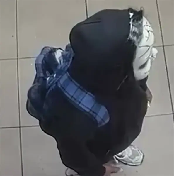 A suspect wearing a Chucky doll style mask and a blue backpack in Philadelphia