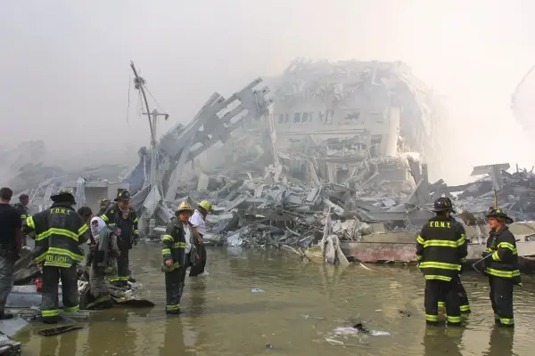 394277 03: New York City firefighters work at the World Trade Center after two hijacked planes crashed into the Twin Towers September 11, 2001 in New York. (Photo by Ron Agam/Getty Images)