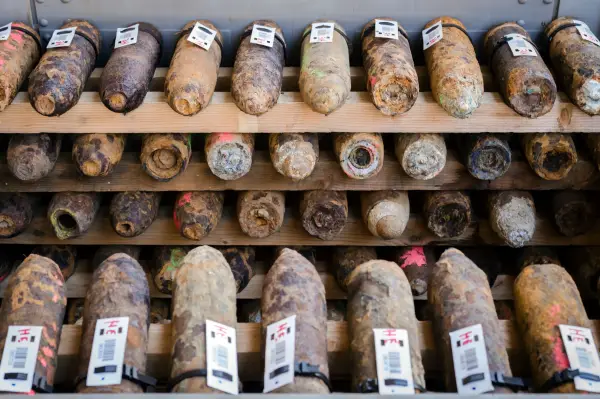 FILE - World War I shells, some marked in pink are suspect gas shells, are piled in a warehouse at the explosive disposal facility (DOVO) in Poelkapelle, Belgium, April 21, 2015. (AP Photo/Geert Vanden Wijngaert, File)