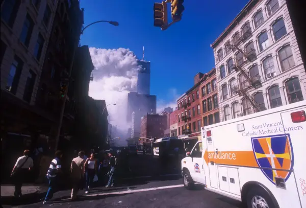 394273 08: An ambulance rushes toward the World Trade Center area after the twin towers collapsed after being struck by a commerical airliner in a suspected terrorist attack September 11, 2001 in New York City. (Photo by Ezra Shaw/Getty Images)