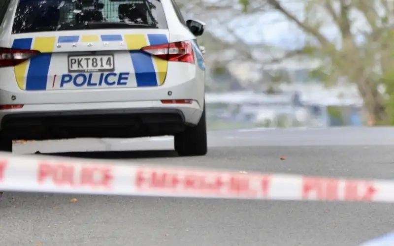 A police car seen behind a cordon as officers attend an incident.