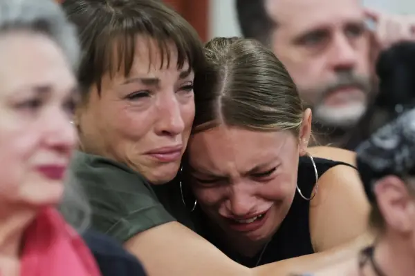 epa12257051 Dylan Mortensen (R) gets a hug after speaking during the sentencing hearing of Bryan Kohberger at the Ada County Courthouse, in Boise, Idaho, USA, 23 July 2025. Kohberger was sentenced to four consecutive life sentences for the 2022 fatal stabbings of four University of Idaho students. EPA/KYLE GREEN / POOL