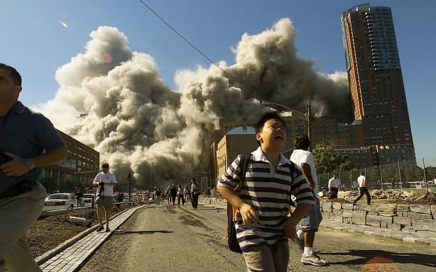 НЬЮ-ЙОРК – 11 ВЕРЕСНЯ 2001 РОКУ: (ПУЕРТО-РІКО ПОЗА) (РЕНОТРОСПЕКТИВА 11 ВЕРЕСНЯ) Люди тікають, коли Північна вежа Всесвітнього торгового центру обвалюється після того, як захоплений літак врізався в будівлю 11 вересня 2001 року в Нью-Йорку. Хосе Хіменес/Primera Hora/Getty Images/AFP (Фото Хосе Хіменеса/Primera Hora / GETTY IMAGES NORTH AMERICA / Getty Images через AFP)