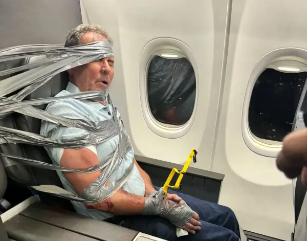 PICTURED: Arthur Lundeen, 67 16107451 American Airlines passenger from hell DUCT-TAPED to seat on flight forced to divert over his terrifying racist and homophobic tirade