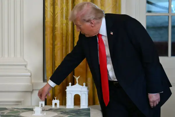 (FILES) US President Donald Trump stands near models for a proposed