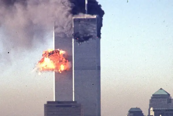 TOPSHOT - A hijacked commercial plane crashes into the World Trade Center 11 September 2001 in New York. The landmark skyscrapers were destroyed in the attack. The all-out war on terrorism unleashed by Washington after the attacks marked a turning point in US-Arab relations and nowhere more so than in once top ally Saudi Arabia. With 15 of the 19 suicide hijackers carrying Saudi nationality and mastermind Osama bin Laden being the scion of a leading Saudi family, the desert kingdom and world oil kingpin, suddenly found itself on the frontline of the war on terror prosecuted by US President George W. Bush. AFP PHOTO SETH MCALLISTER (Photo by SETH MCALLISTER / AFP) (Photo by SETH MCALLISTER/AFP via Getty Images)