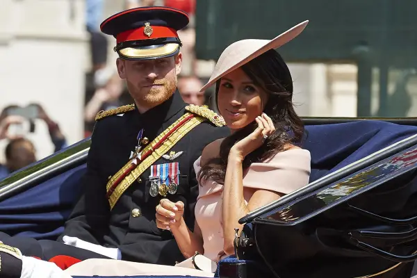 (FILES) Britain's Prince Harry, Duke of Sussex and Britain's Meghan, Duchess of Sussex return in a horse-drawn carriage after attending the Queen's Birthday Parade, 'Trooping the Colour' on Horseguards parade in London on June 9, 2018. Britain's Prince Harry, his wife Meghan Markle and their two children, landed on August 26, 2026, in Britain, UK media reported, after news emerged last week they would be relocating from the United States. (Photo by Niklas HALLE'N / AFP via Getty Images)