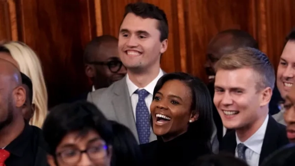 WASHINGTON, DC - OCTOBER 04: Turning Point USA founder Charlie Kirk (top), Candace Owens (C) and her husband George Farmer join other guests while listening to U.S. President Donald Trump addresses an event for the Young Black Leadership Summit in the East Room of the White House October 04, 2019 in Washington, DC. A conservative nonprofit political group, Turning Points USA organized the summit which bills itself as a professional development, leadership training and networking opportunity. (Photo by Chip Somodevilla/Getty Images)